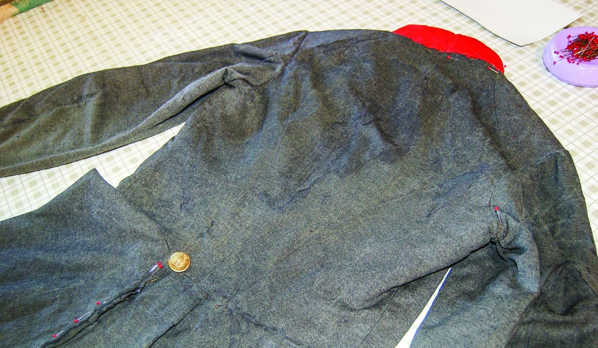 Back of the coat after the holes were couched to the new wool support material.