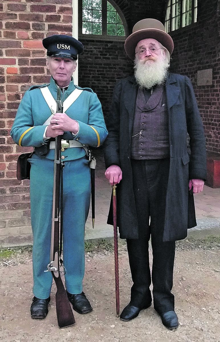 John Brown, portrayed by Steve Hanson, and reenactor Bob Werner of Macungie, Penn., stand in front of the U.S. Arsenal Fire House in Harpers Ferry. (Photos by Joe Bordonaro)