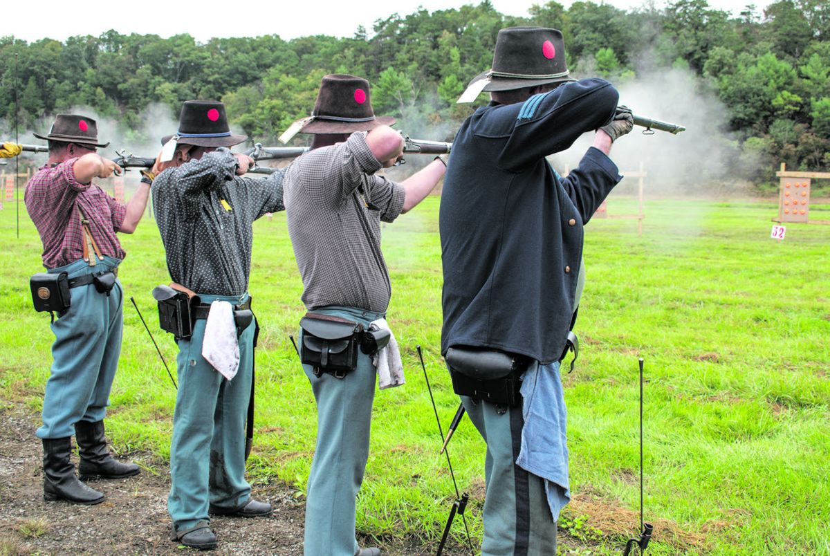 The Union Guards’ Smoothbore musket team includes three generations of the Robey family, and the fourth team member who is married to a Robey. From left to right: Phil Spaugy (who is married to the aunt/sister/daughter of the other three), Thomas James “TJ” Robey, Tom Robey (TJ’s Dad), and John Robey (Tom’s Dad).