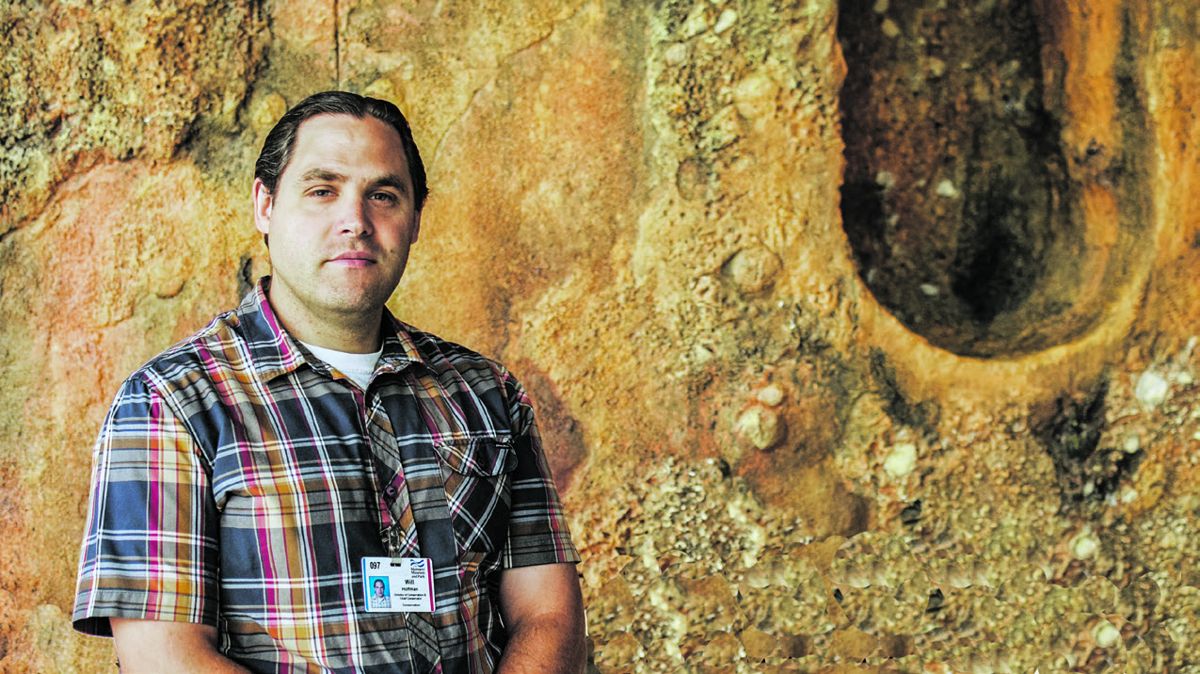 Will Hoffman is the director of conservation and the chief conservator at the Mariners’ Museum in Newport News. Behind Hoffman is a full-scale replica of the turret of the USS Monitor as it appeared when it arrived at the USS Monitor Center.