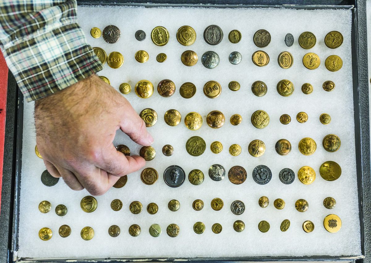 William Leigh picking out a rare button for a customer.