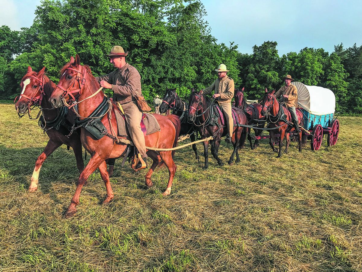 Confederate teamsters haul regimental baggage in a period, refurbished wagon.