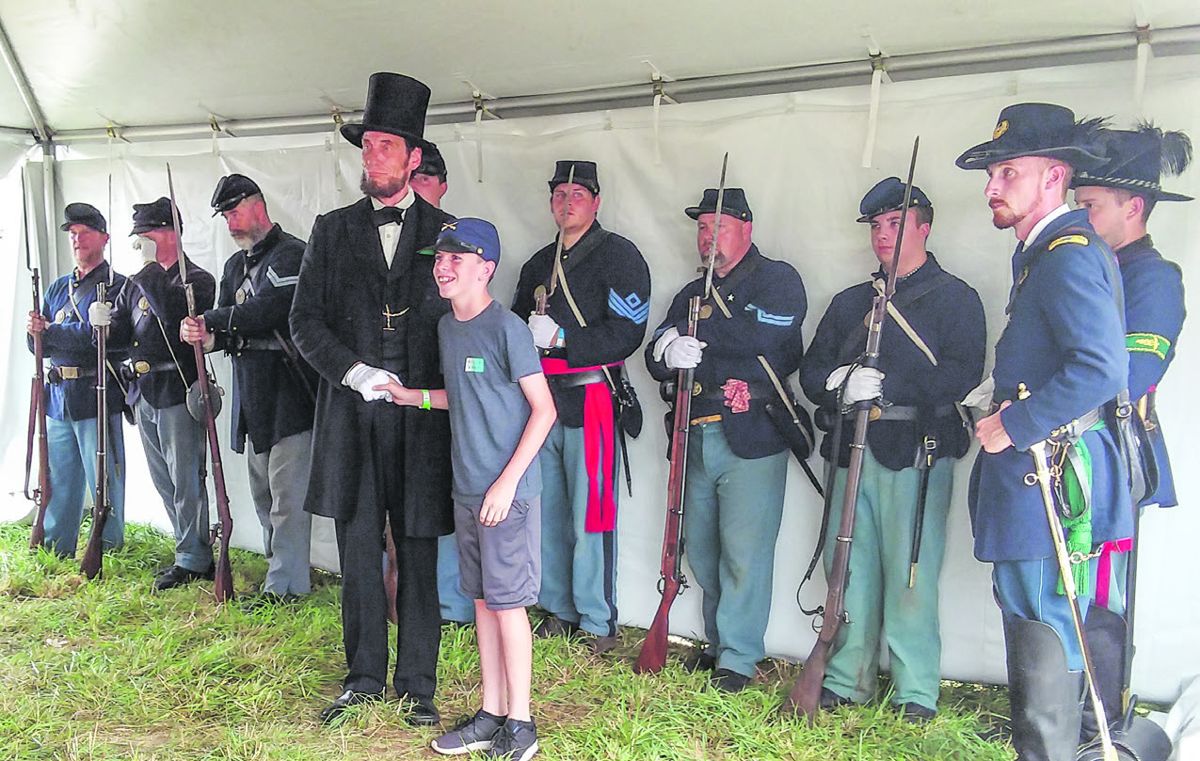 Abraham Lincoln impressionist Don Mullen brings a big smile to a young fan.