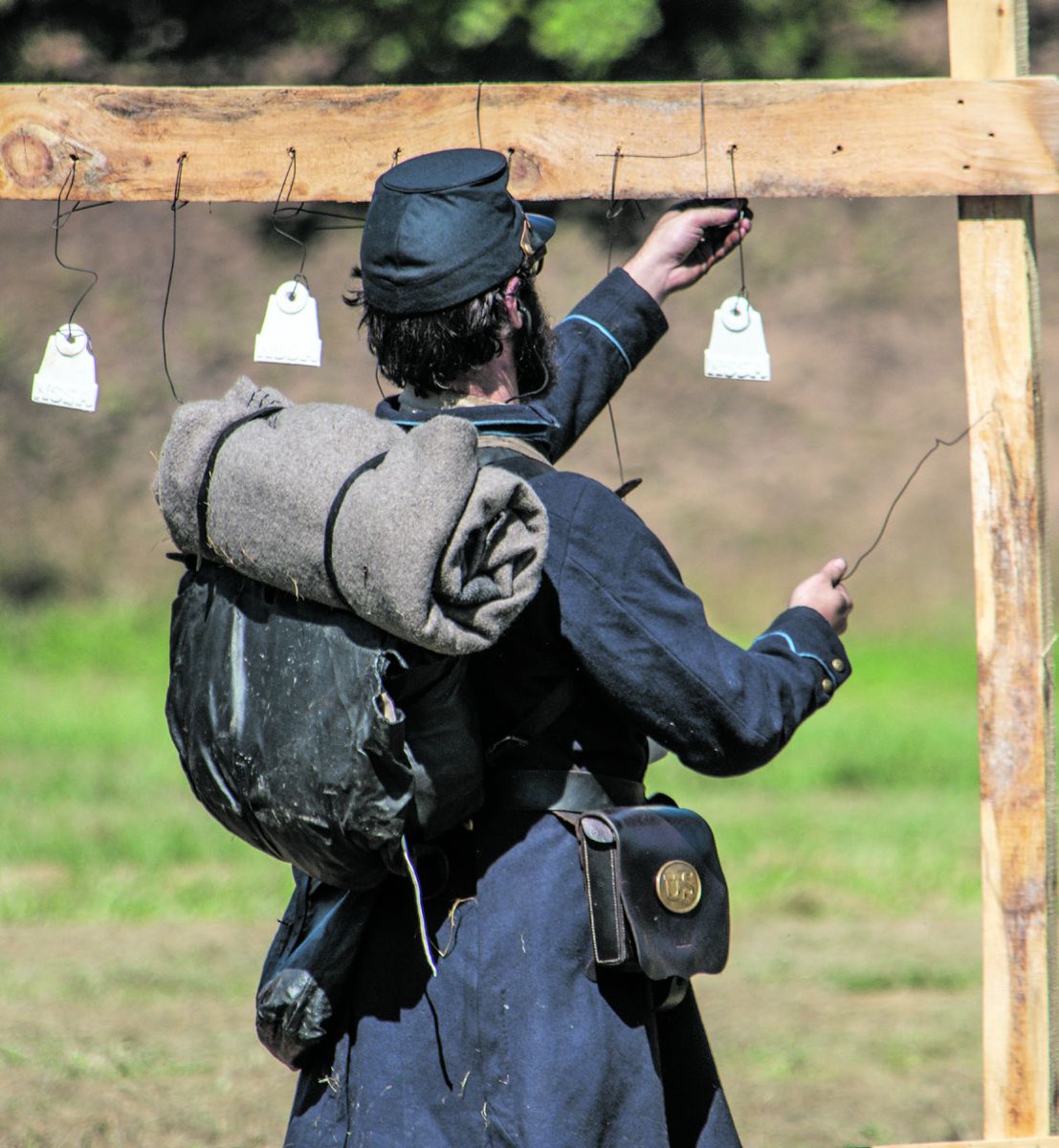 Brent Feito, 1st Maryland Infantry, hangs clay pot silhouettes between events of the Smoothbore Musket Team match. Ericka Hoffmann Curley.