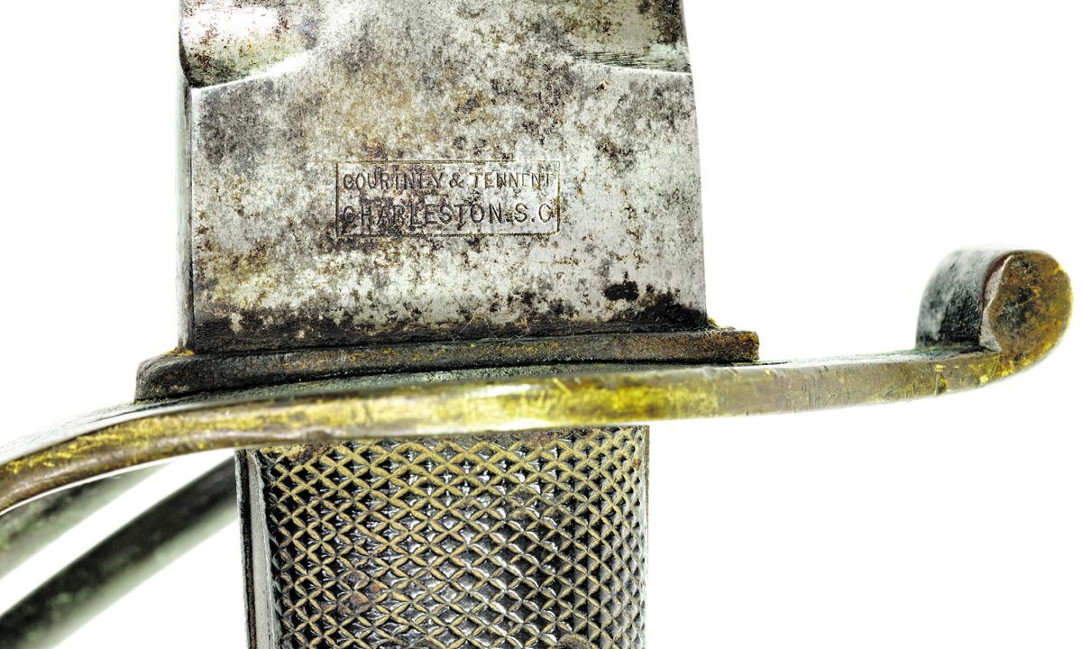 Overall obverse view of a Courtney & Tennent marked Confederate Naval Cutlass produced by Robert Mole. This is the most common variant with the three-branch brass cavalry guard. The scabbard has lost the black leather surface finish due to flaking. Photo by Tim Prince.