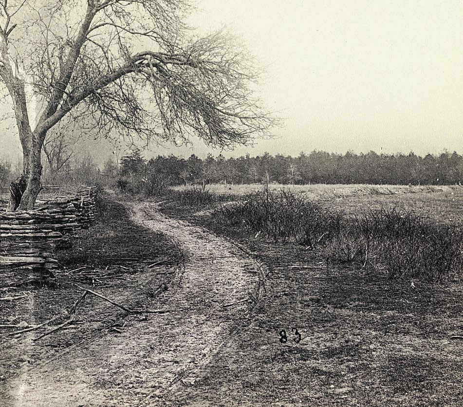Here, Brock Road intersects with Piney Branch Road about 3.5 miles from Spotsylvania Court House. Union troops built earthworks here (the light color in front of the tree line) and there was a field hospital in the area. Library of Congress.