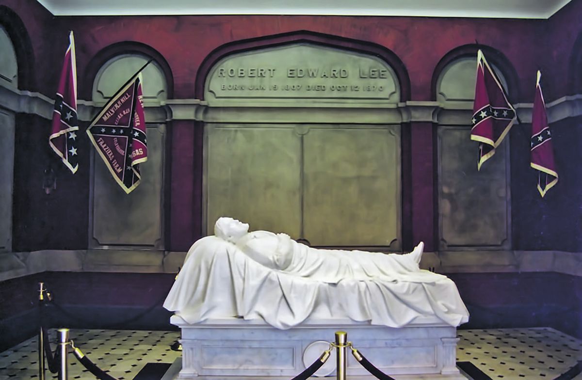 “Recumbent Statue” of Robert E. Lee asleep on the battlefield, by Edward Valentine. Located in the Lee Chapel in Lexington, Va., it is often mistakenly thought to be a tomb or sarcophagus, but Lee is actually buried beneath the chapel. In the summer of 2014, the replica Confederate flags pictured in this photo were removed from the chapel after student protests.