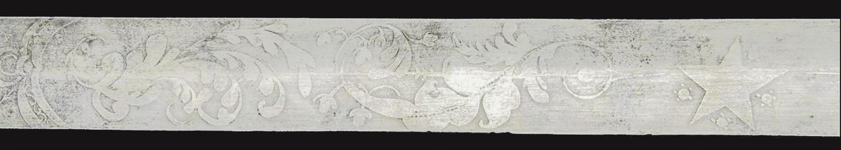 The large central star, one of several etched onto the blade. Note the extremely finely etched detailing.