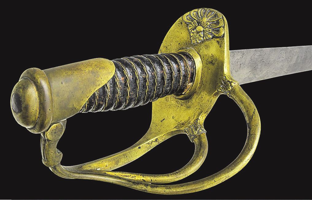 The sword’s quillon is embossed with a French style foliate spray.