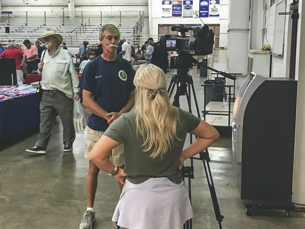 Media participation helped bring in the public. Here, promotor Mark Shulser is interviewed at the arena by a
