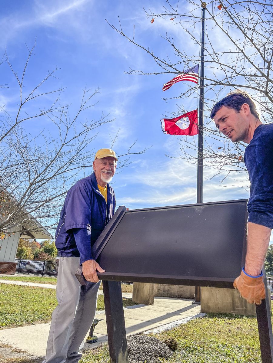 Alderman Jim Whitaker (left) was on hand to help assist Chris Brown, Assistant Director of Civil War Trails place the new interpretive sign now located at 101 E. Depot Ave., Monterey, TN 38574. (Courtesy, Civil War Trails, Inc.)