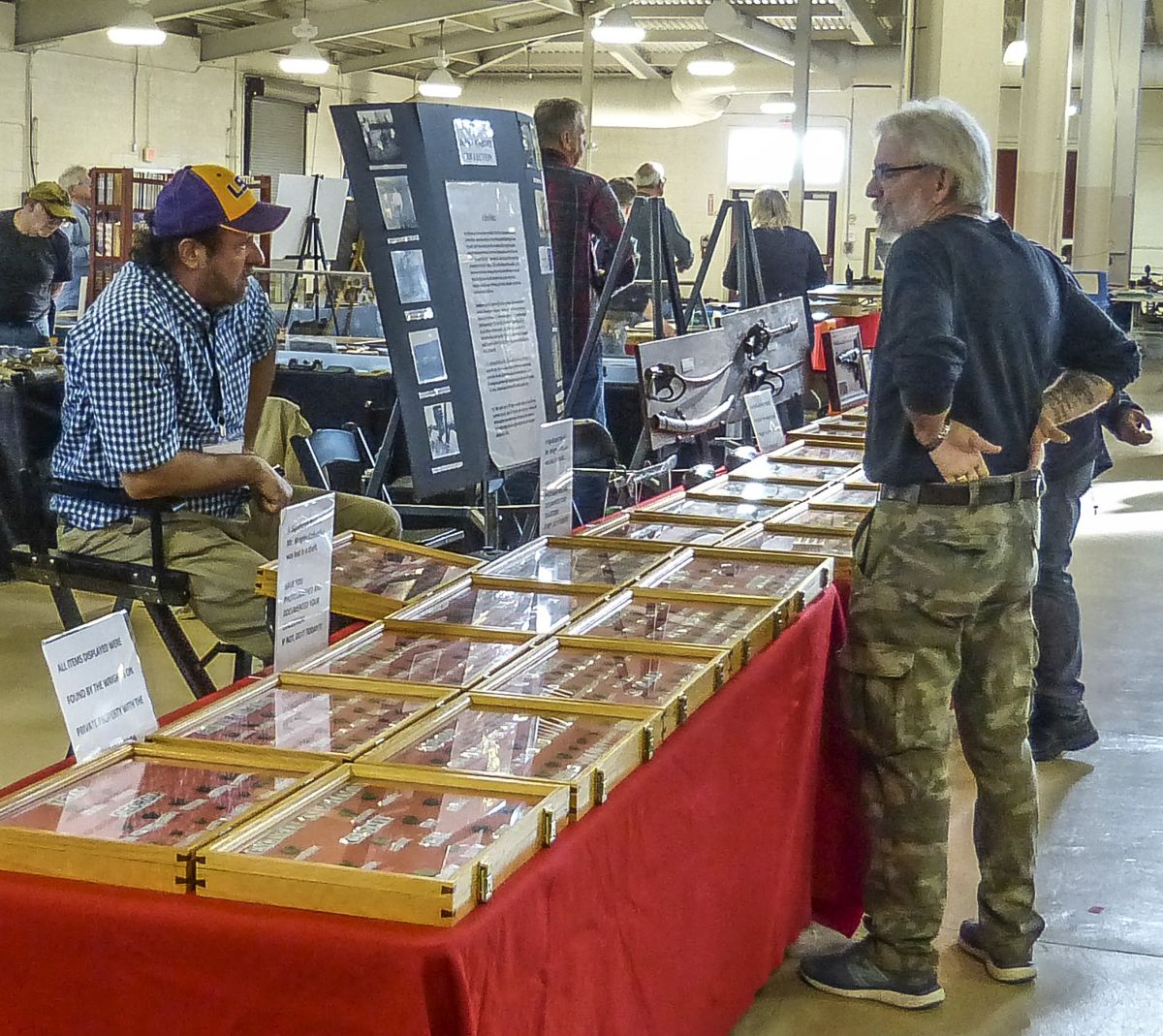 Mike Wright proudly shows his award winning display of “My Father’s Relics” to an interested patron.