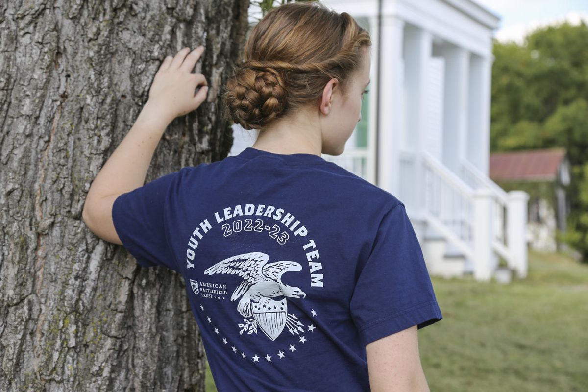 Member of 2022-23 Youth Leadership Team sports her team member t-shirt. Photo by Laurel Roots Photography.