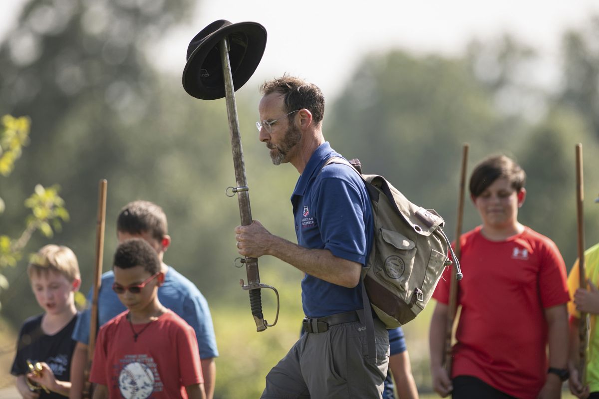 Chief Historian Garry Adelman leads “Generations” program participants in an activity in the field. Photo by Noel Kline.